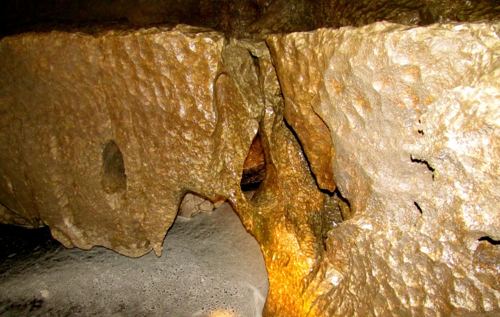 The limestone wall here is rotting away, thanks to the river below it and the water running down the walls. The white foam on the surface of the water is caused by minerals from peat and such mixing with the calcium carbonate of the walls and reacting in foam. And this being Ireland, they call the white foam on brown water the Guinness Head.