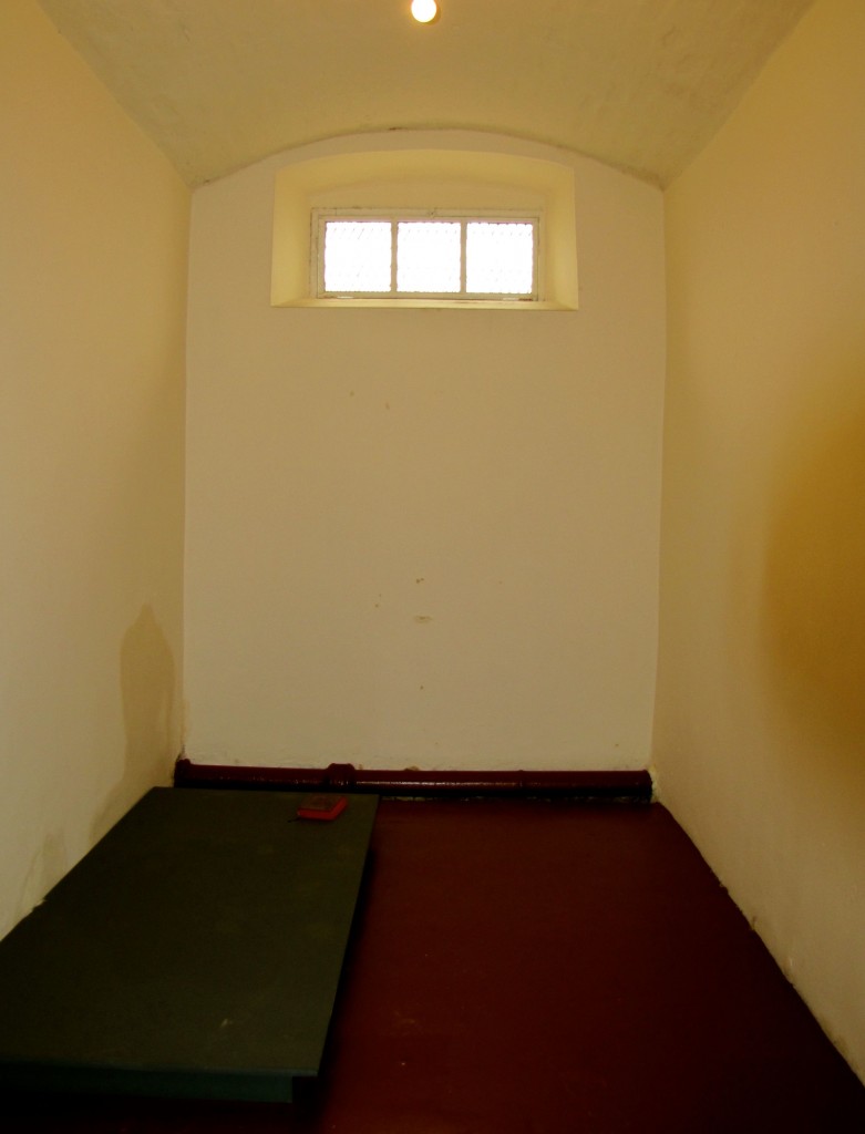 This is a punishment cell. Note the absence of bedding - bedding was provided at night, but during the day, you could sit or lie only on the floor or on the wooden pallet. Thus, being sent to the punishment cell was called "being on the boards."