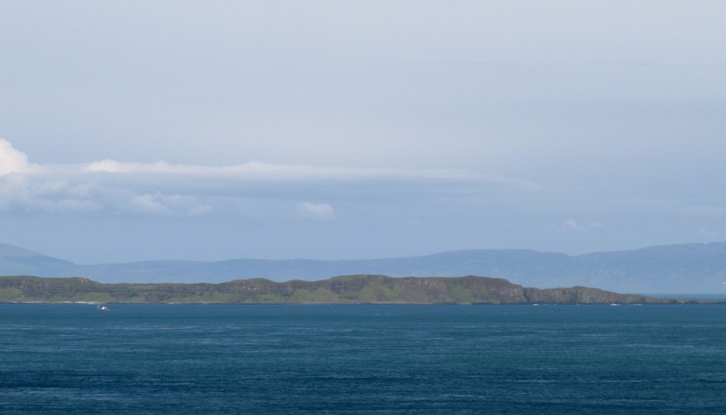 The island in the foreground is Rathlin Island. Interesting place. Behind it, the shadowy outline is the Mull of Kintyre - it's actually part of shoreline of Scotland, about twelve miles away.