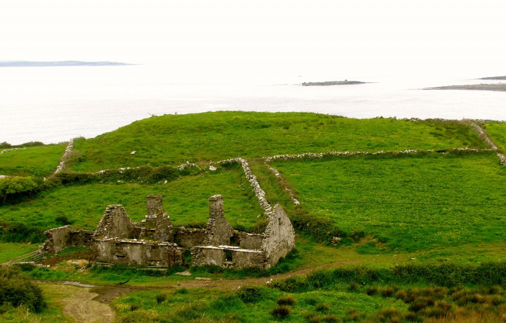 An old stone house, with stone fences, and the Atlantic beyond.