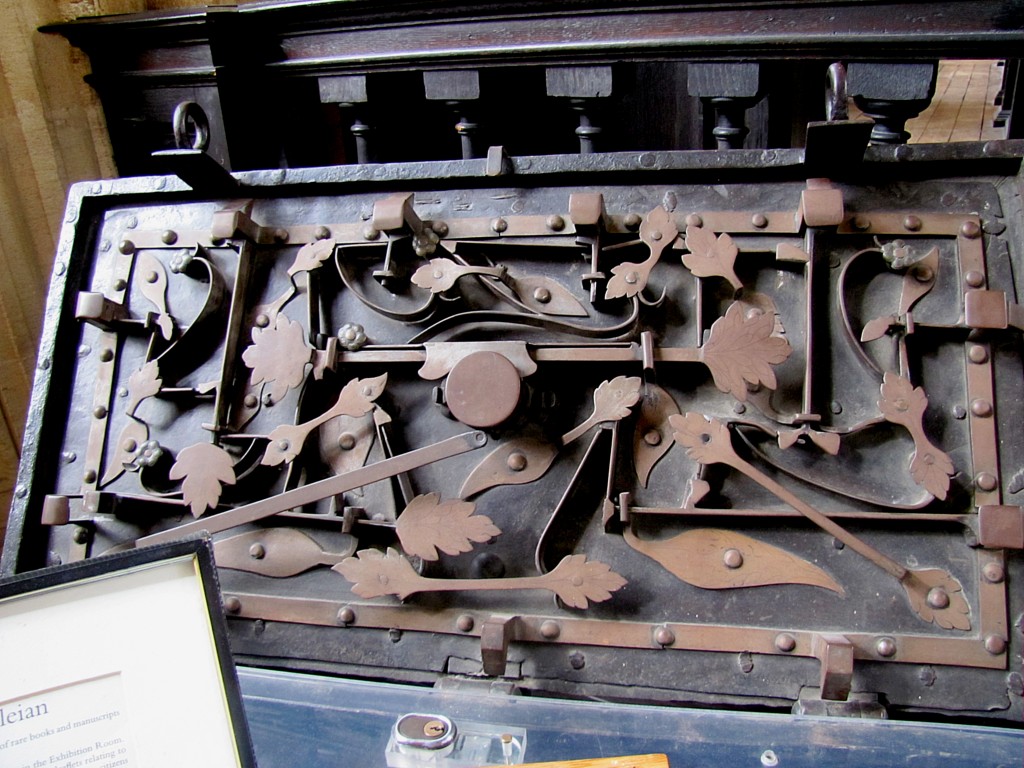 In here with a slot for donations, sits Thomas Bodley's black iron strongbox. The lid is open and, as you can see, the underside is a complex set of levers, rods, springs, and plates. These are the rather elaborate locks that were used to secure the chest.