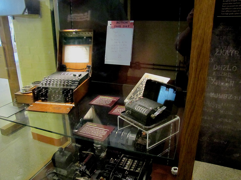 These are what it was all about. You've got an Enigma machine on the left, a much simpler Italian cipher machine on the right, and some pads above. The bottom shelf holds the much more complex Lorenz cipher machine.